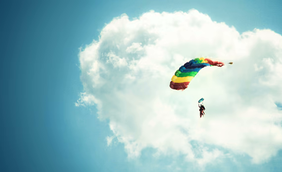 Blue sky with clouds and a paraglider